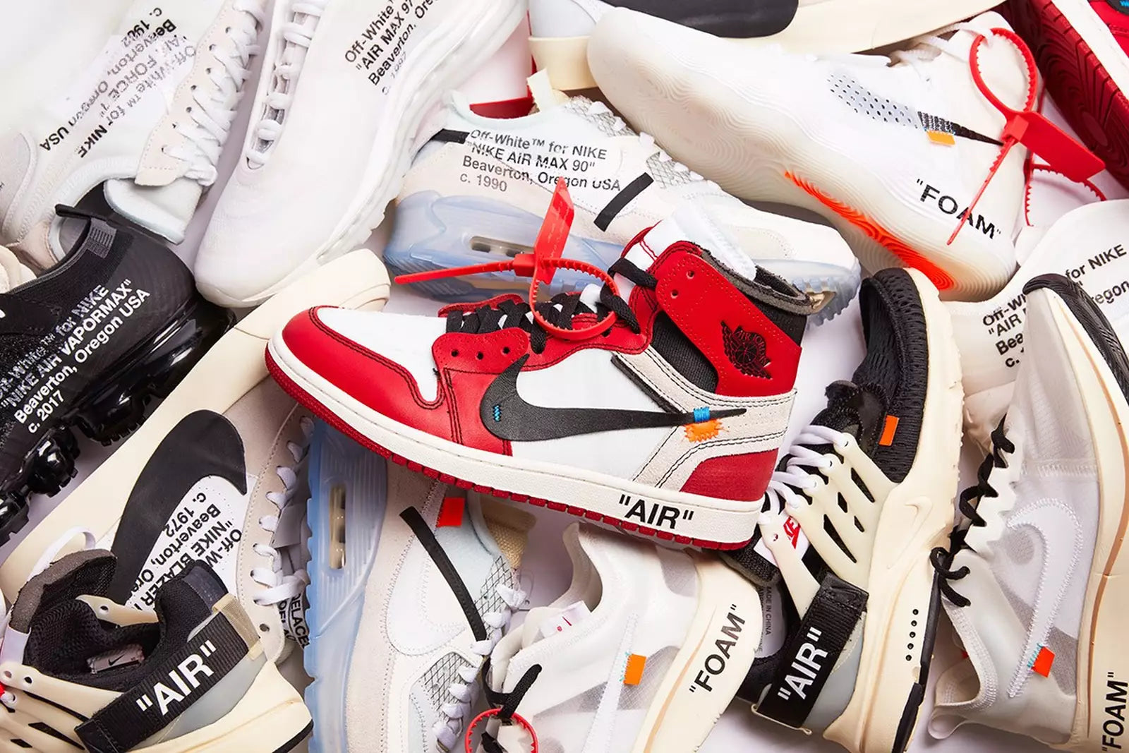 A mixture of shoes in a pile to show the variety of shoe brands that we offer.