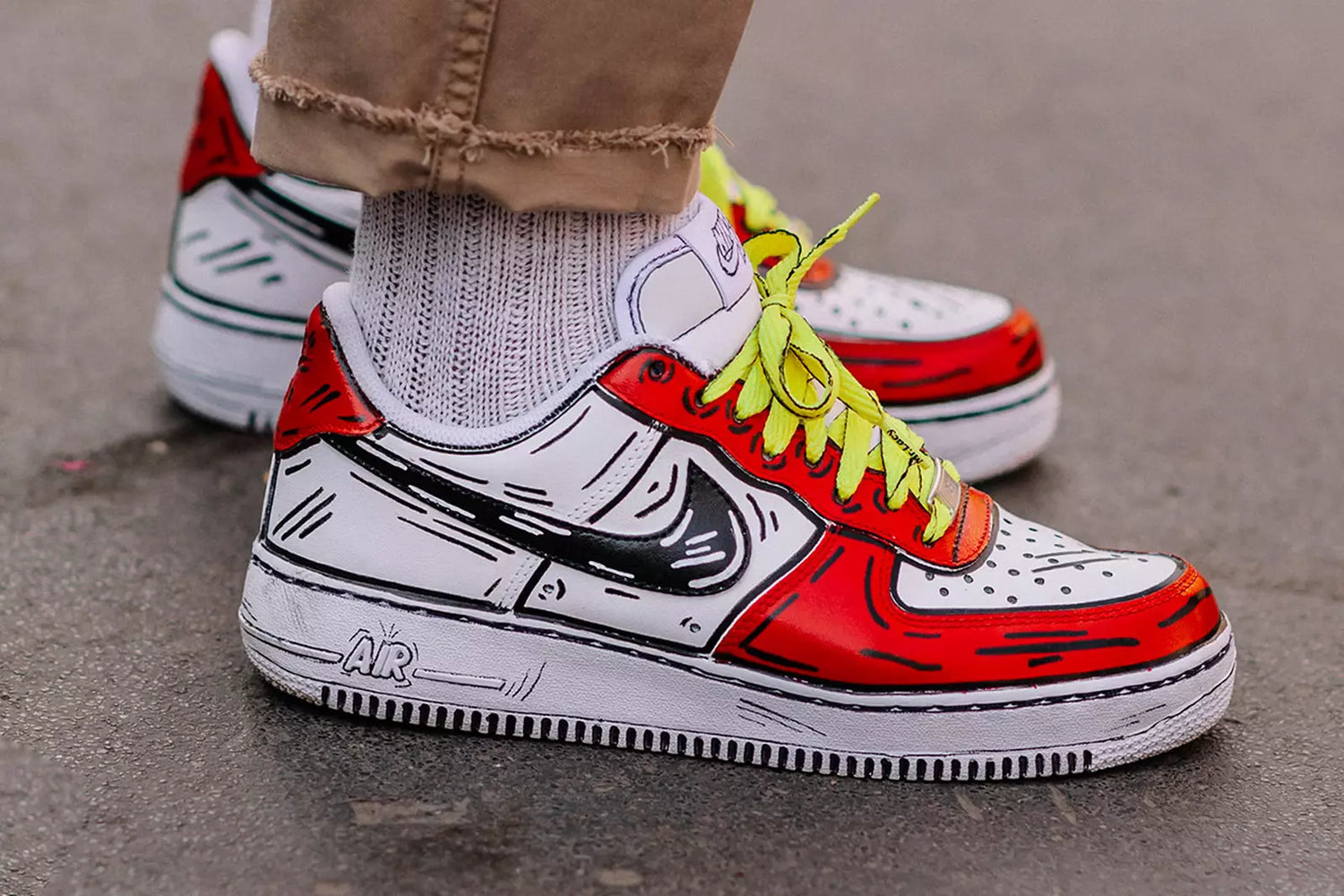 Customized colorful shoes that have a unique drawing on them.